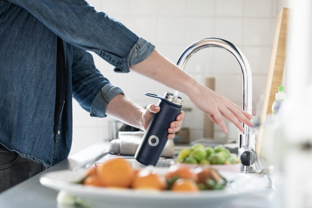 Person filling up a water bottle