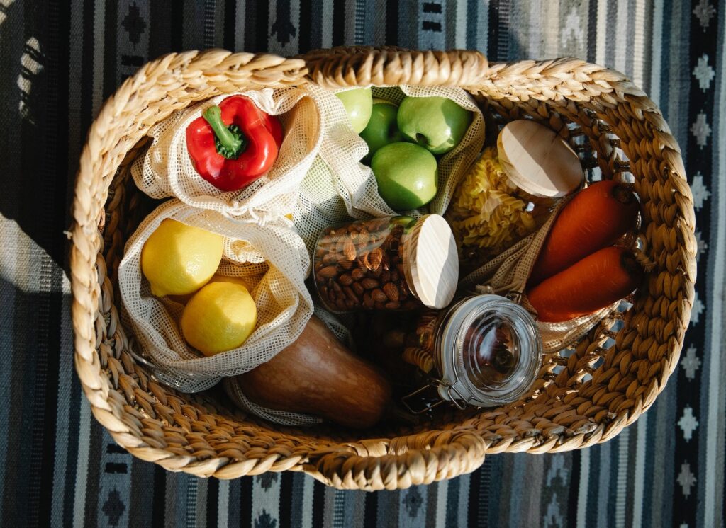 A basket of fruit, vegetables, and grains