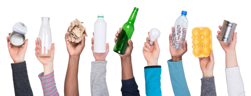 Hands holding up items for recycling