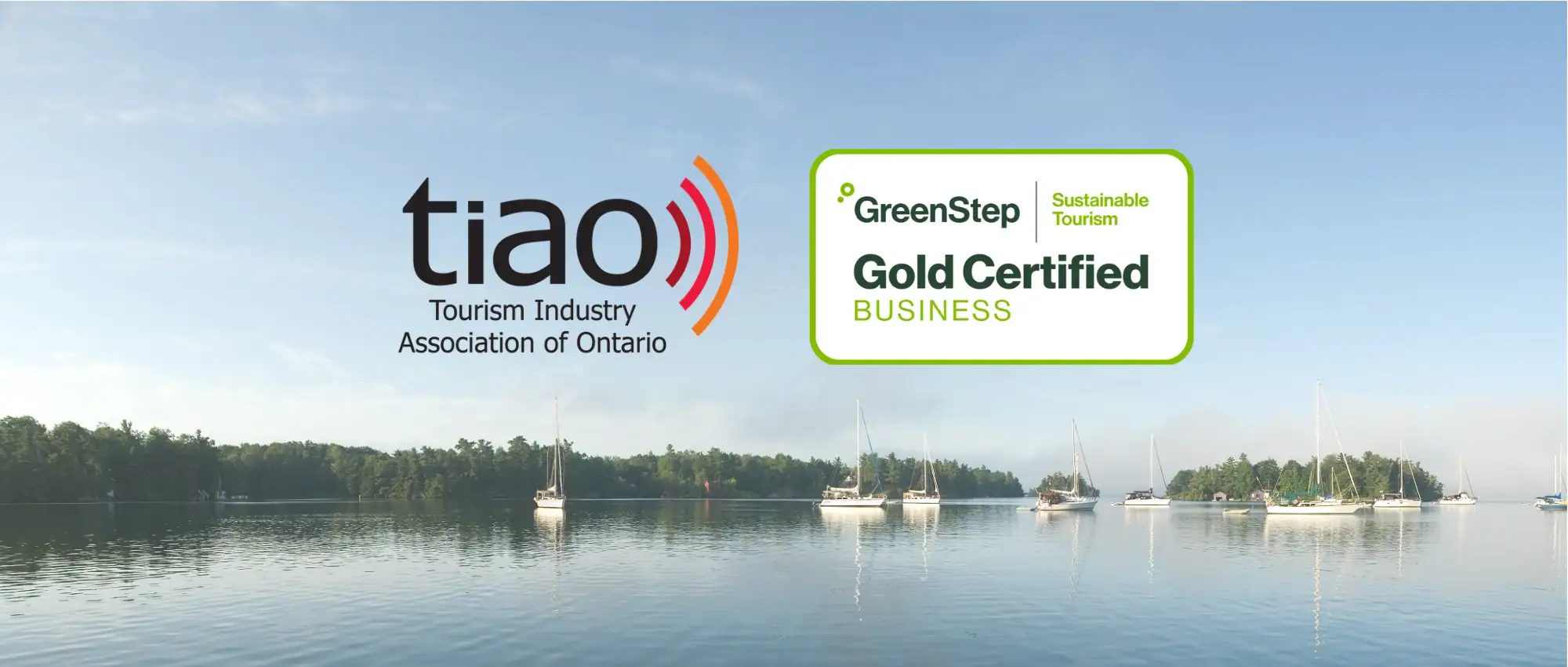Tourism Industry Association Ontario (TIAO) GreenStep Gold Certified Business | Sustainable Tourism, in front of photo of St Lawrence River